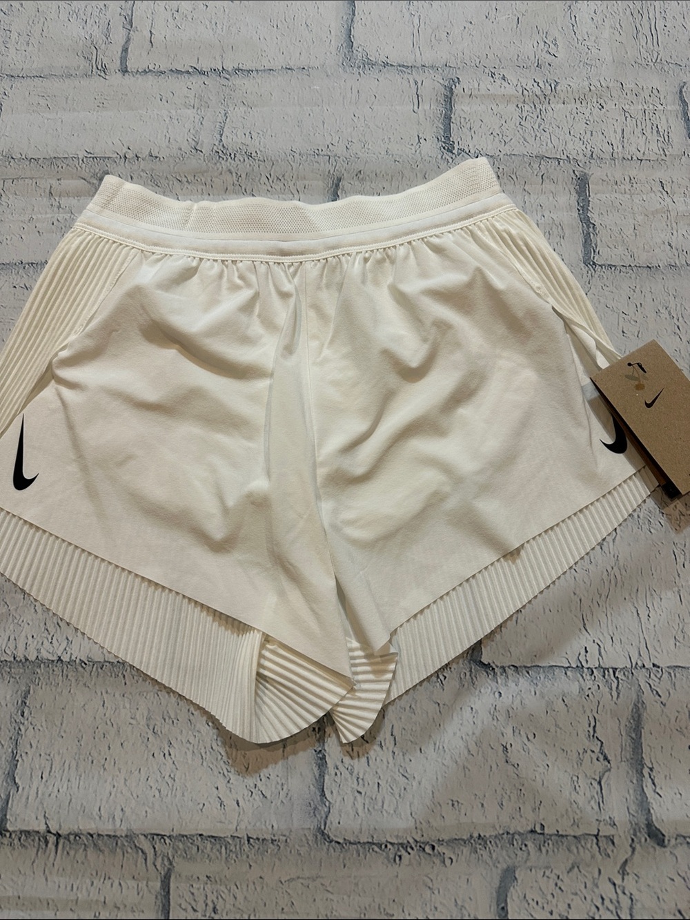 NWT Nike Women’s white pleated back Athletic Running Shorts with Black Swoosh